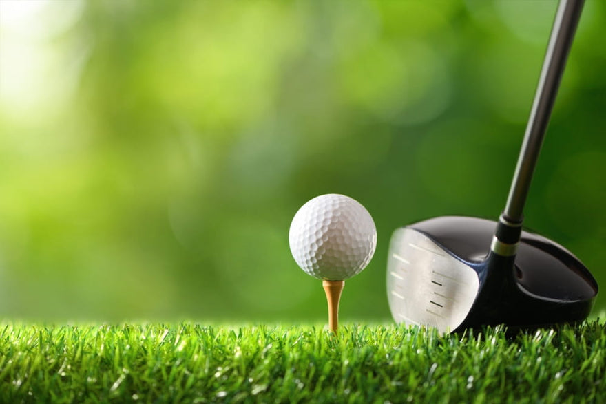 golf ball on tee with golf drivers